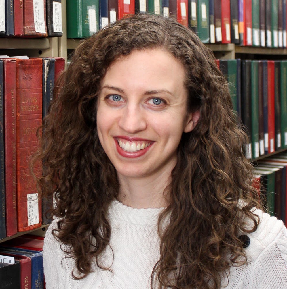 Headshot of Ann Dyer in front of books