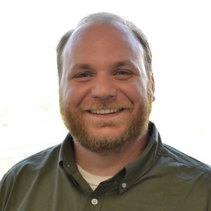 Headshot of James W. Rosenzweig, facing the camera and smiling