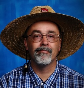 Ryan Grant, a white male with a beard wearing a straw hat