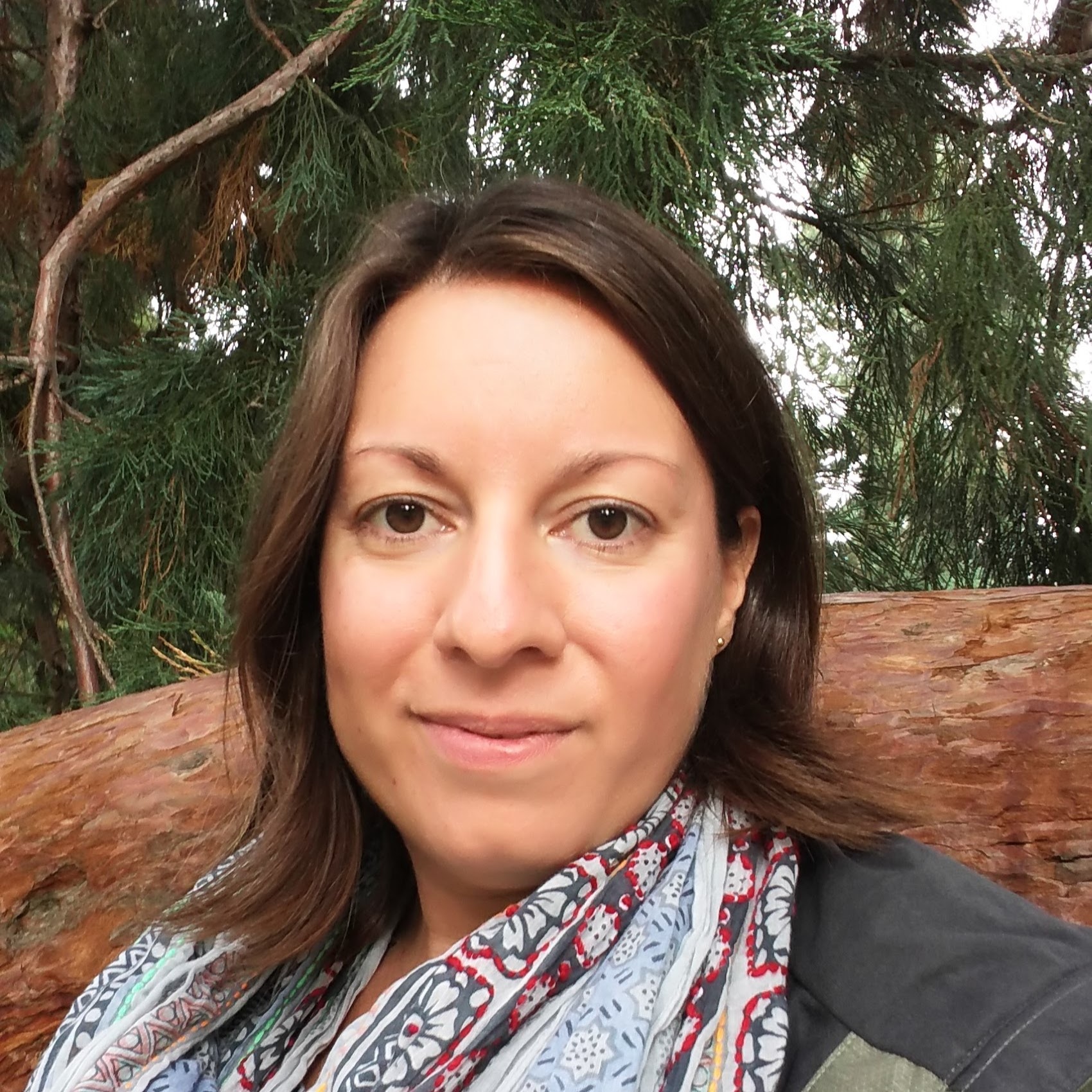 Headshot of Liz Ebersole in front of a Giant Sequoia tree in Volunteer Park in Seattle.
