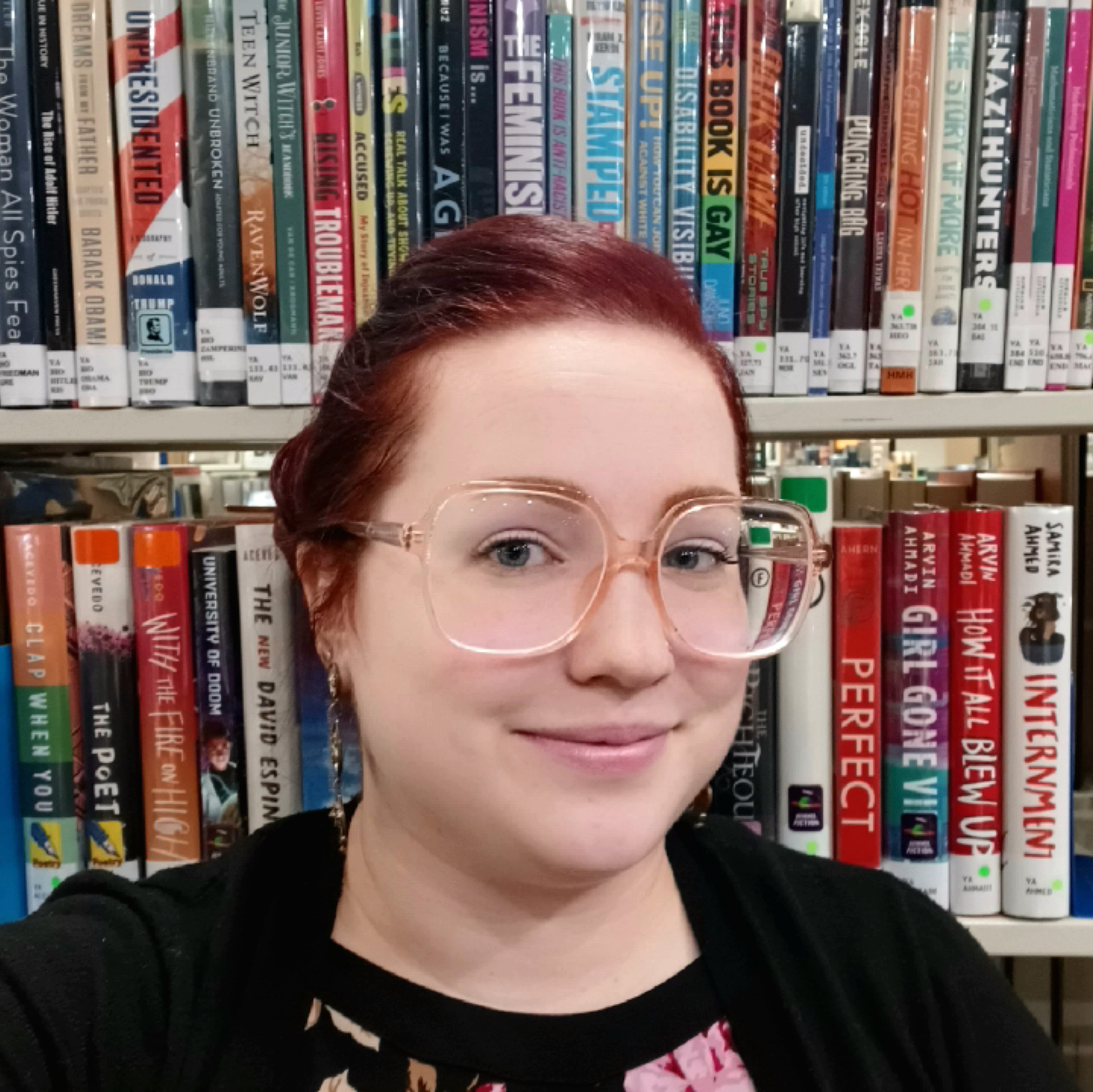 Headshot of Mikayla Kittilstved in front of library bookshelves.