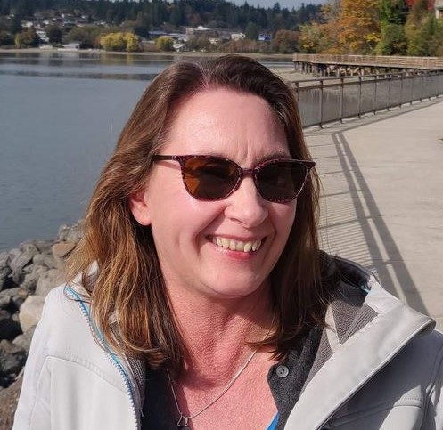 Headshot of Shawn Schollmeyer wearing sunglasses at the Poulsbo waterfront. 