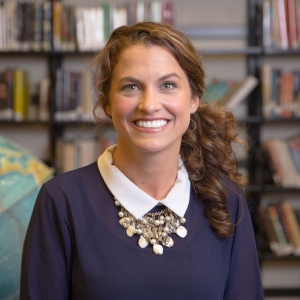 Headshot of TuesD Chambers with globe behind her