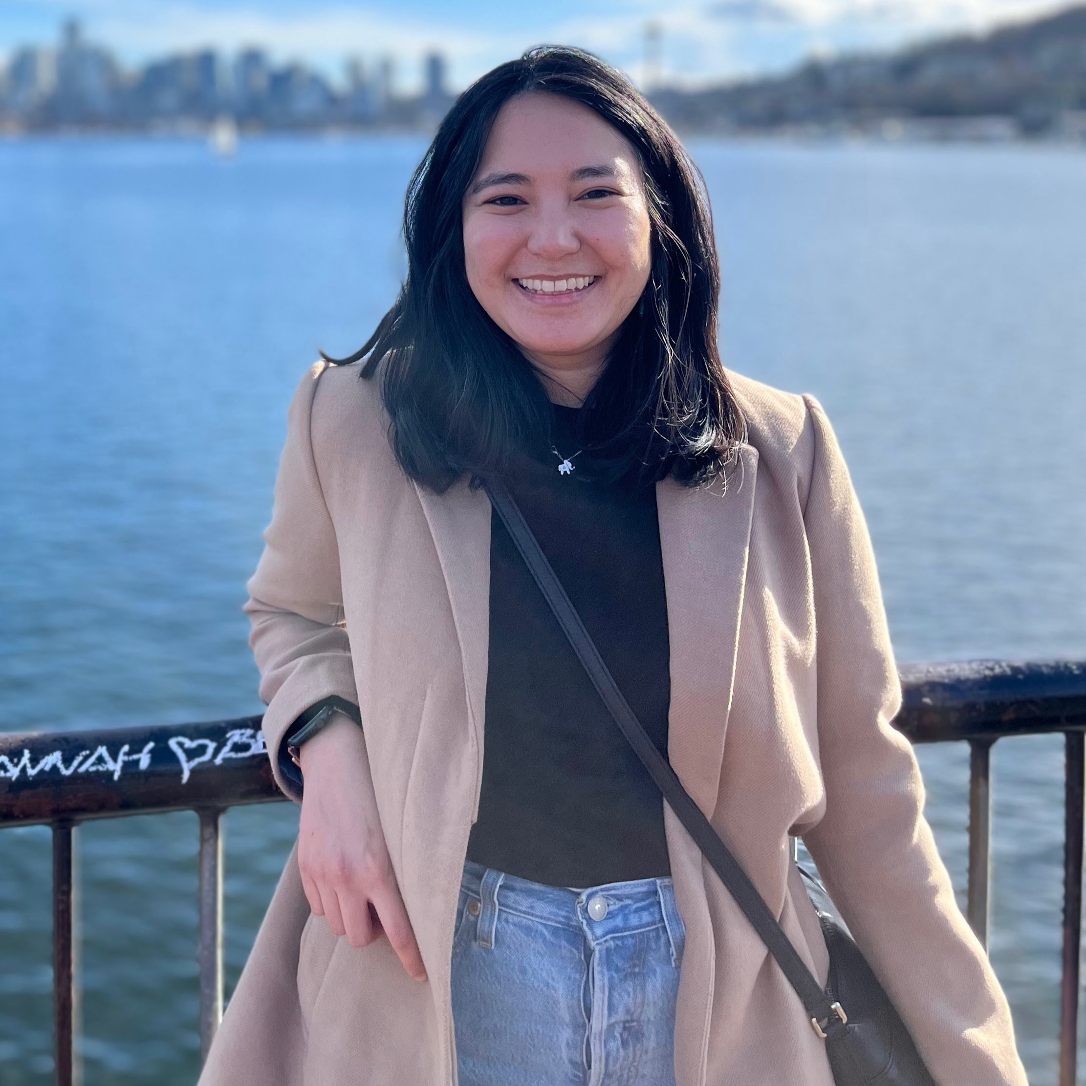 Asian woman posing in front of Seattle skyline